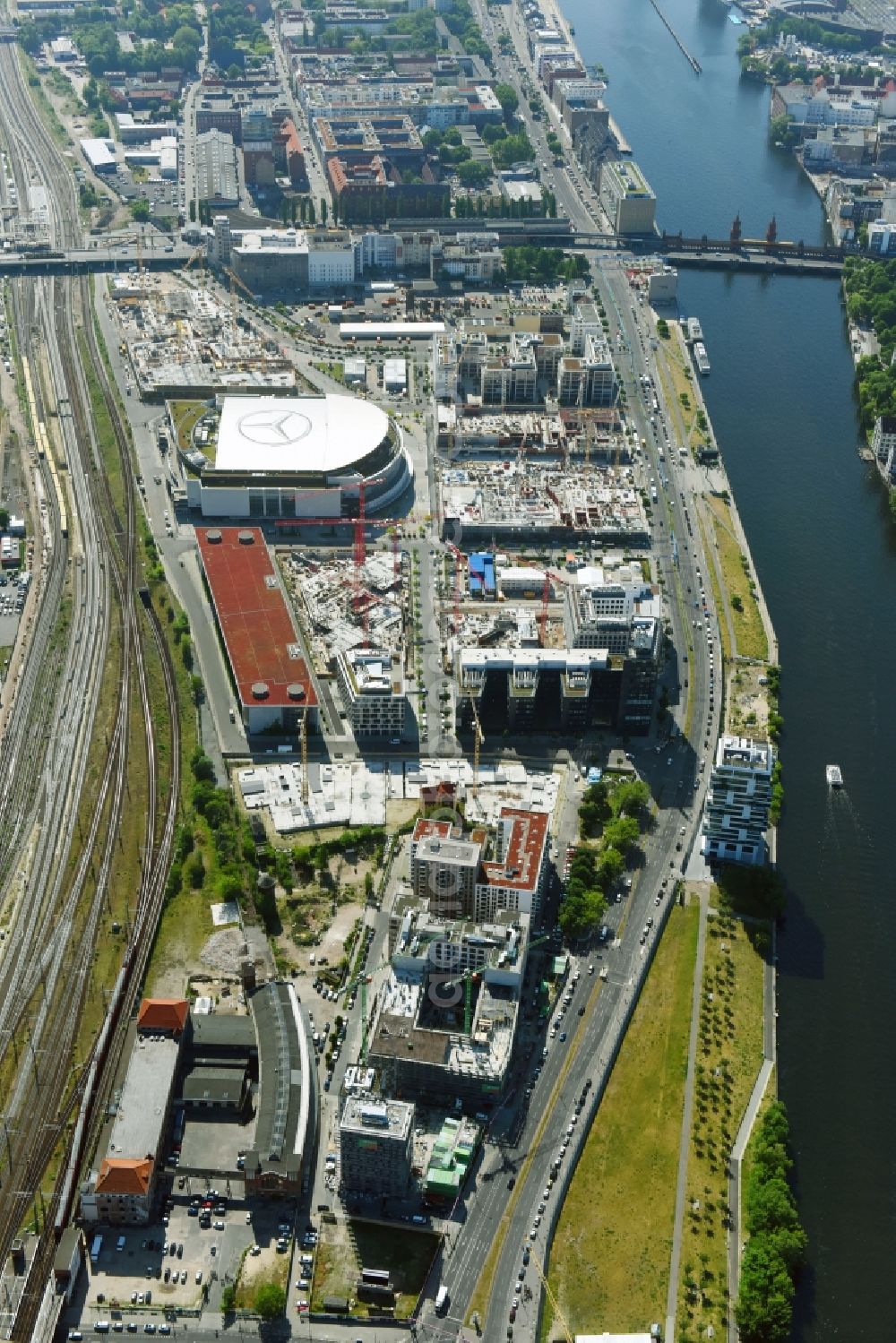 Aerial photograph Berlin - Development area and construction sites on the Anschutzareal at the Mercedes-Benz-Arena on the banks of the River Spree in Friedrichshain. The Anschutz Entertainment Group (AEG) is developing the site through numerous hotel and commercial building new buildings