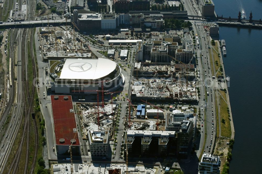 Aerial image Berlin - Development area and construction sites on the Anschutzareal at the Mercedes-Benz-Arena on the banks of the River Spree in Friedrichshain. The Anschutz Entertainment Group (AEG) is developing the site through numerous hotel and commercial building new buildings