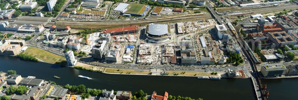 Aerial image Berlin - Development area and construction sites on the Anschutzareal at the Mercedes-Benz-Arena on the banks of the River Spree in Friedrichshain. The Anschutz Entertainment Group (AEG) is developing the site through numerous hotel and commercial building new buildings