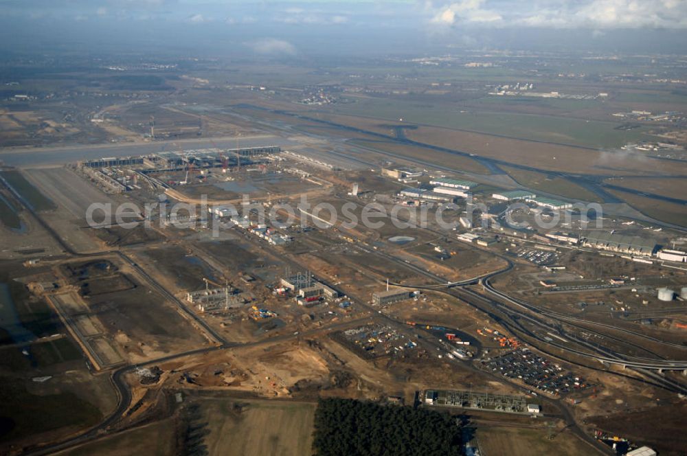 Schönefeld from the bird's eye view: Blick auf die Baustellen am Flughafen Berlin-Schönefeld BBI (SXF). Ausführende Firmen: Hochtief AG; EUROVIA Beton; PORR; BERGER Bau; Karl Weiss; Matthai; Schäler Bau Berlin GmbH; STRABAG; MAX BÖGL. Baustellen am Flughafen Berlin-Schönefeld BBI - Construction fields at Berlin-Schoenefeld Airport BBI.