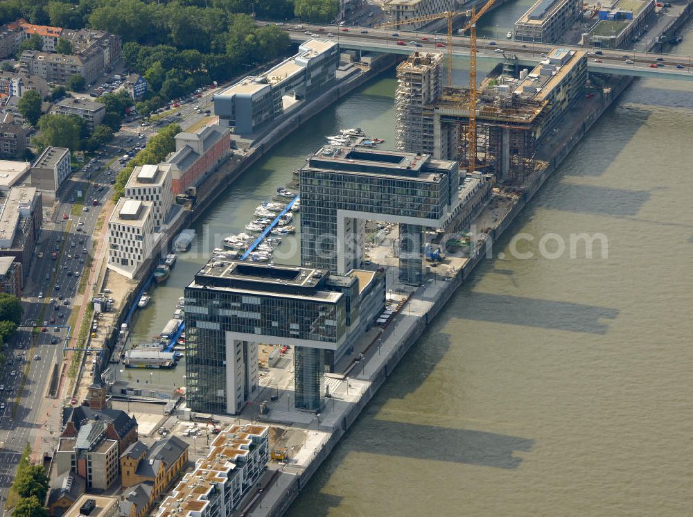 Aerial image Köln - Blick auf die Baustellen der Kranhäuser am Kölner Rheinauhafen. Die Bürogebäude sind alle ca. 60 Meter hoch, 34 Meter breit und haben eine Länge von 70 Metern. Entworfen wurden sie vom Architekturbüro BRT Bothe Richter Teherani. Das mittlere Kranhaus, das Kranhaus1 (hier links im Bild), war das erste, der drei Bürohäuser, das gebaut wurde und setzte den Anstoß für das nördliche und südliche Kranhaus. Kontakt: BRT Bothe Richter Teherani Architekten, Oberbaumbrücke 1 20457 Hamburg Bürohaus Deichtor, Tel. +49(0)40 24842 0, Fax +49(0)40 24842 222, Email: office@brt.de