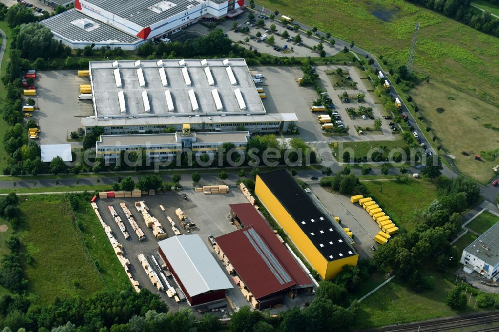 Hennigsdorf from the bird's eye view: Building Materials and logistics center Holz- and Baustoffhandel GmbH Luecke on Walter-Kleinow-Ring in Hennigsdorf in the state Brandenburg, Germany