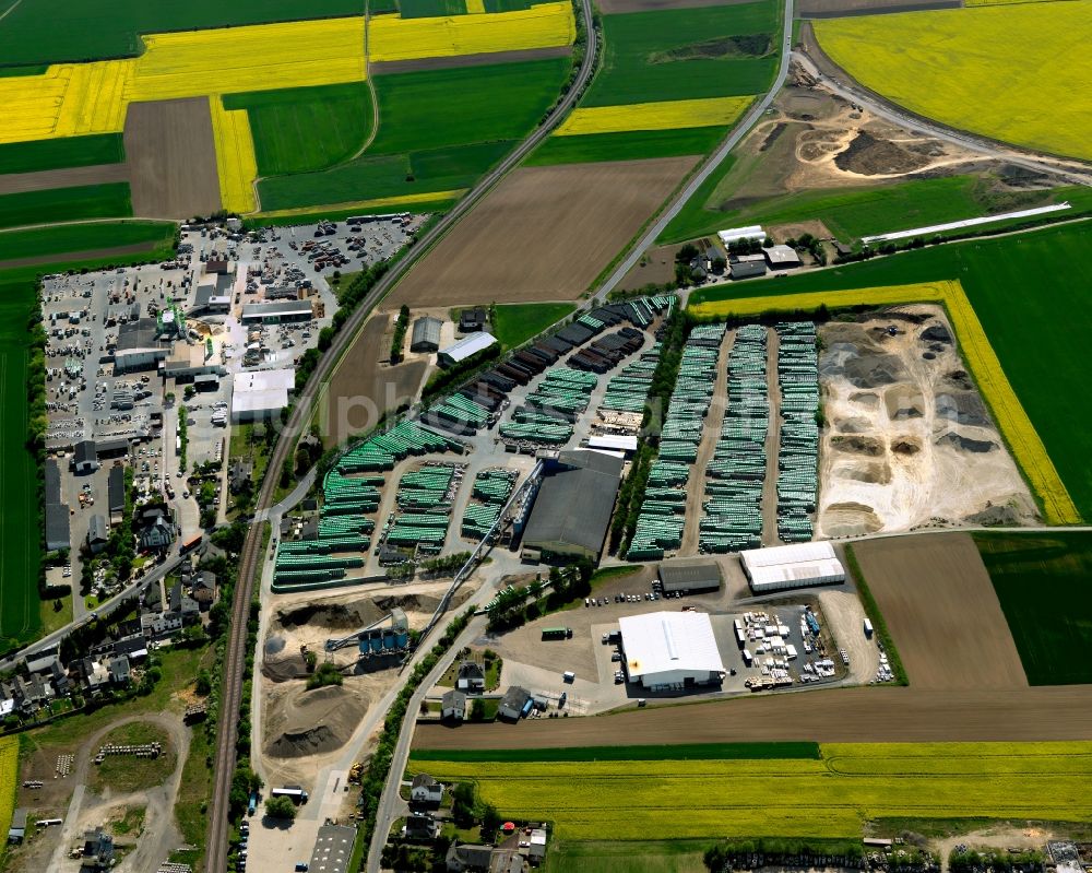 Kruft from above - Building material works in Kruft in the state of Rhineland-Palatinate. The agricultural borough and municipiality is located in the county district of Mayen-Koblenz and surrounded by meadows and rapeseed fields. In the west of the borough, the works and shops of Quick-Mix-Group and EHL AG are located