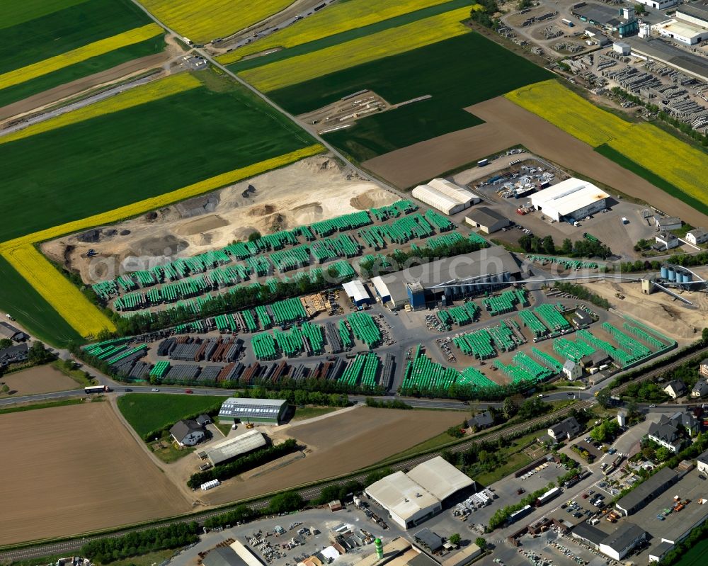 Kruft from the bird's eye view: Building material works in Kruft in the state of Rhineland-Palatinate. The agricultural borough and municipiality is located in the county district of Mayen-Koblenz and surrounded by meadows and rapeseed fields. In the west of the borough, the works and shops of Quick-Mix-Group and EHL AG are located