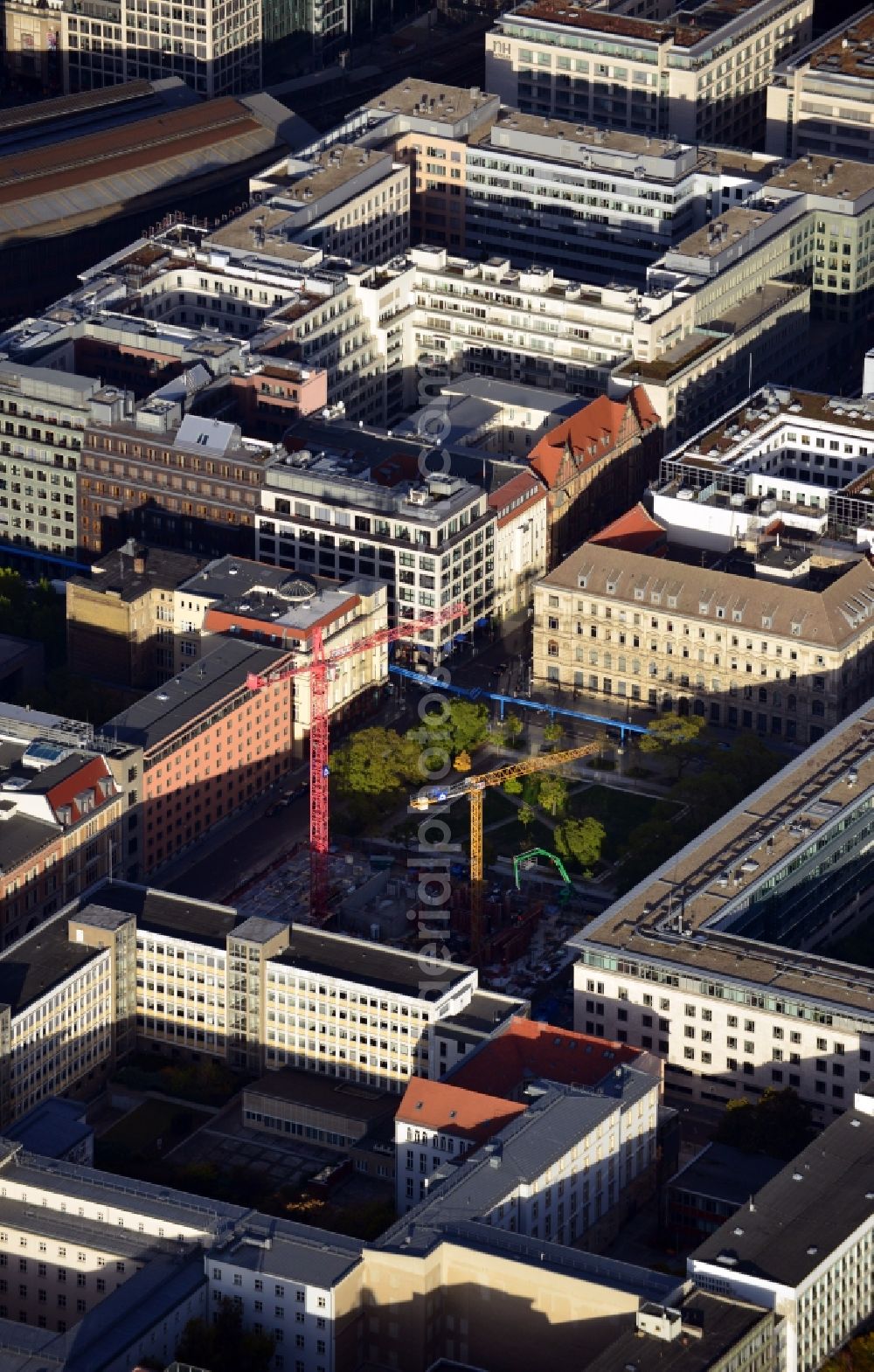 Aerial image Berlin - View of the construction site of the residential complex Lux at Neustaedtischer Kirchplatz in Berlin - Mitte. Developing companies of the building complex with its modern luxurious apartments and commercial space are Ziegert banking and real estate consulting GmbH and HOCHTIEF AG. The plans for the building were designed the architectural firm Axthelm Rolvien GmbH & Co. KG