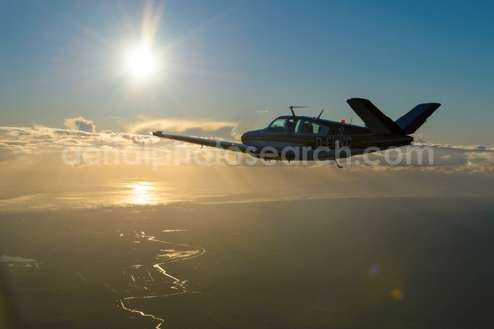 Bremerhaven from above - Beechcraft Bonanza D-EHVC in flight over the Weser-estuary in the North Sea near Bremerhaven in the state of Bremen, Germany. The Beechcraft Model 36 Bonanza is produced by Beech Aircraft Corporation as a travel and business aircraft