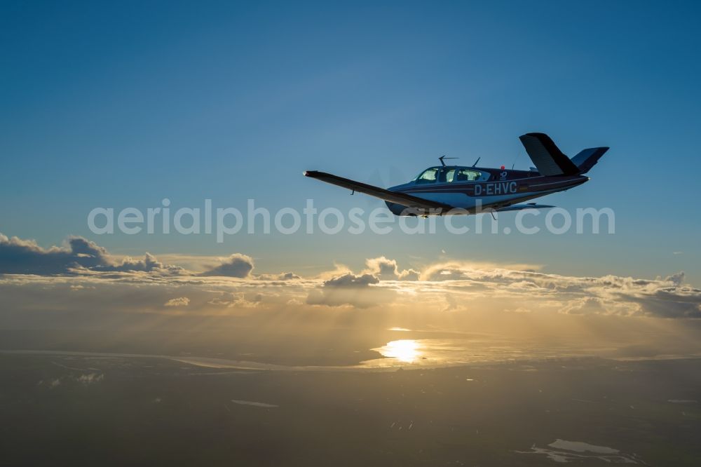 Aerial photograph Bremerhaven - Beechcraft Bonanza D-EHVC in flight over the Weser-estuary in the North Sea near Bremerhaven in the state of Bremen, Germany. The Beechcraft Model 36 Bonanza is produced by Beech Aircraft Corporation as a travel and business aircraft