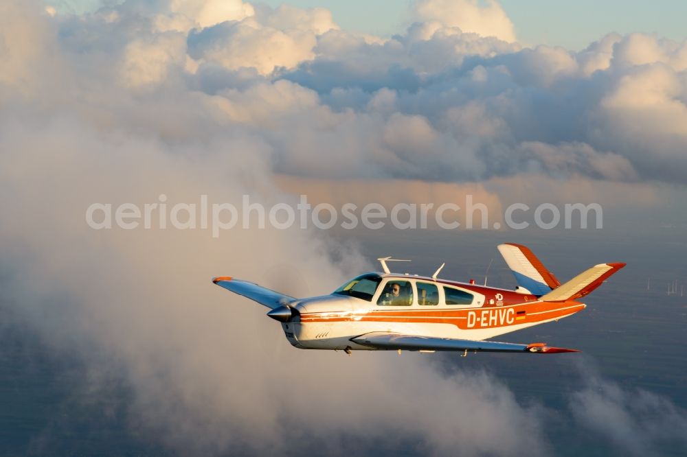 Geestland from the bird's eye view: Beechcraft Bonanza D-EHVC in flight near Geestland in the state of Bremen, Germany. The Beechcraft Bonanza is produced by Beech Aircraft Corporation as a travel and business aircraft