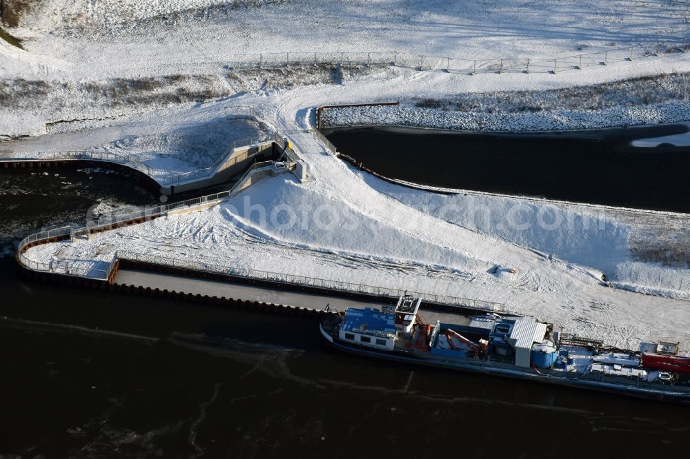 Aerial photograph Elbe-Parey - In winter snow and ice parked weather specialized vessels on the banks of the Elbe-Havel canal in Guesen in Saxony-Anhalt