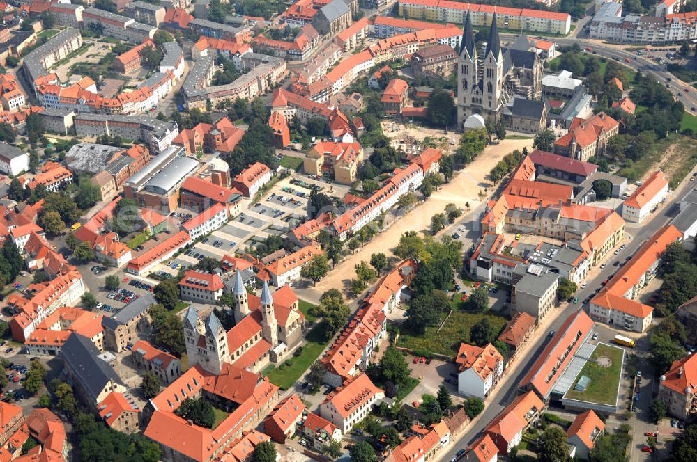 Aerial photograph Halberstadt - Beide Gotteshäuser sind Teil der Strasse der Romanik, welche durch Sachsen-Anhalt führt. Die äußerlich burgartige Liebfrauenkirche (rotes Dach) ist die einzige viertürmige Basilika aus der Zeit der Romanik in Mitteldeutschland. Der Dom zu Halberstadt (schwarzes Dach) ist einer der wenigen großen Kirchenbauten des französischen Kathedralschemas in Deutschland.