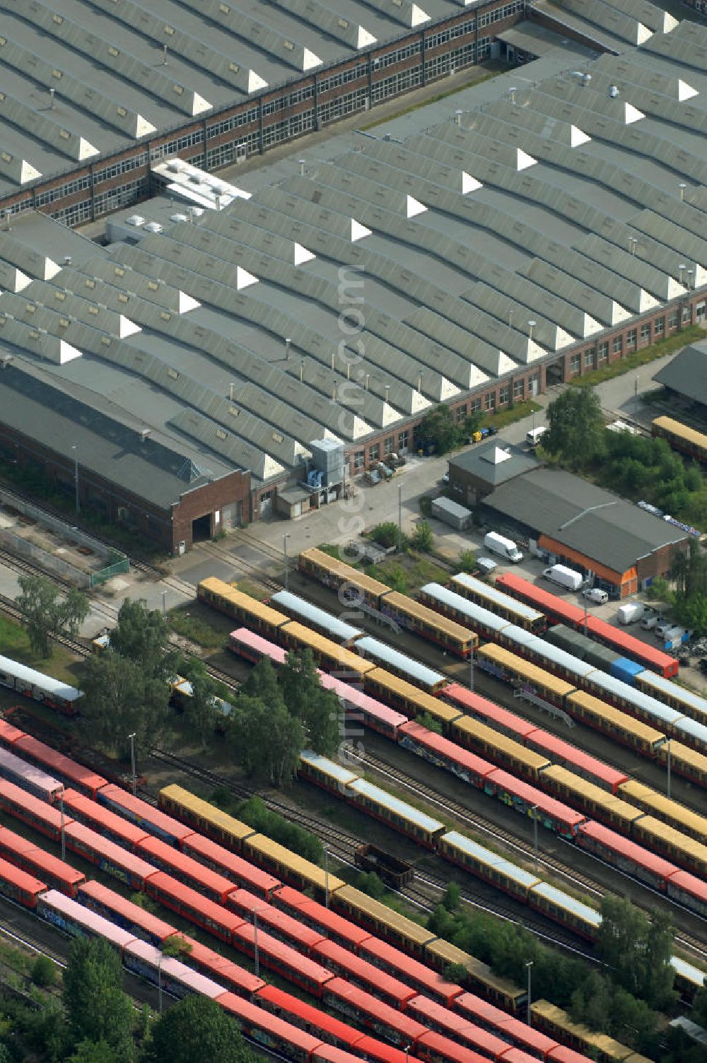 Berlin from the bird's eye view: Blick auf die überfüllten Abstellgleise vor den Reparaturhallen der S-Bahn-Hauptwerkstatt / Bahnbetriebswerk, auf Grund wiederholter Mängelfälle, in Berlin-Schöneweide. View of the overcrowded sidings with city trains in front of the engine terminal / facilities in Berlin-Niederschöneweide.