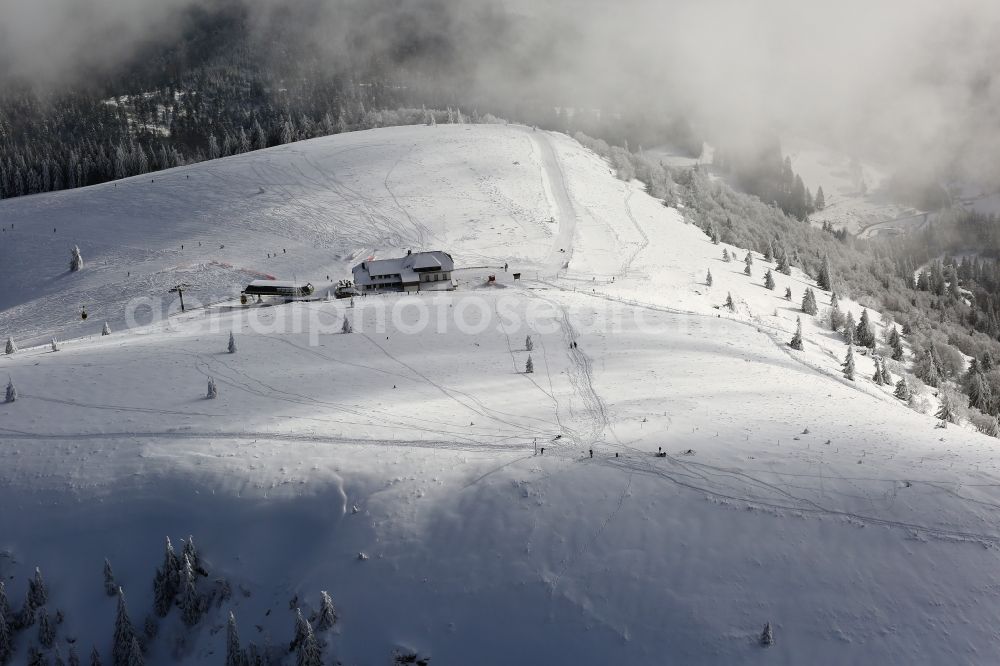 Schönenberg from above - Snow-covered peak of Belchen in the Black Forest in Schoenau in the state of Baden- Wuerttemberg . The Belchen house can only be reached on foot or by the Belchen cableway