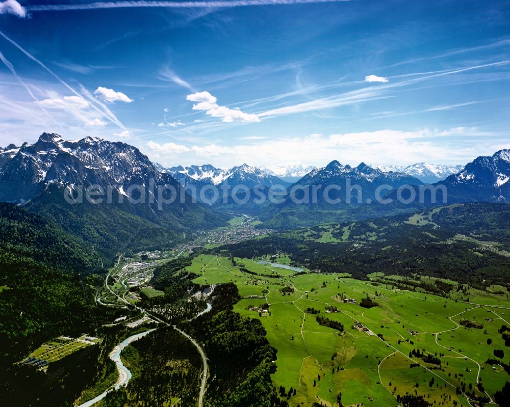 Aerial image Sonthofen - Mountain panorama of the Allgaeu Alps in Sonthofen in the state of Bavaria. Sonthofen is surrounded by mountain tops and mountains of the Alps. Meadows, fields and villages are located in broad valleys which are surrounded by the snow-covered mountain tops of the mountain range