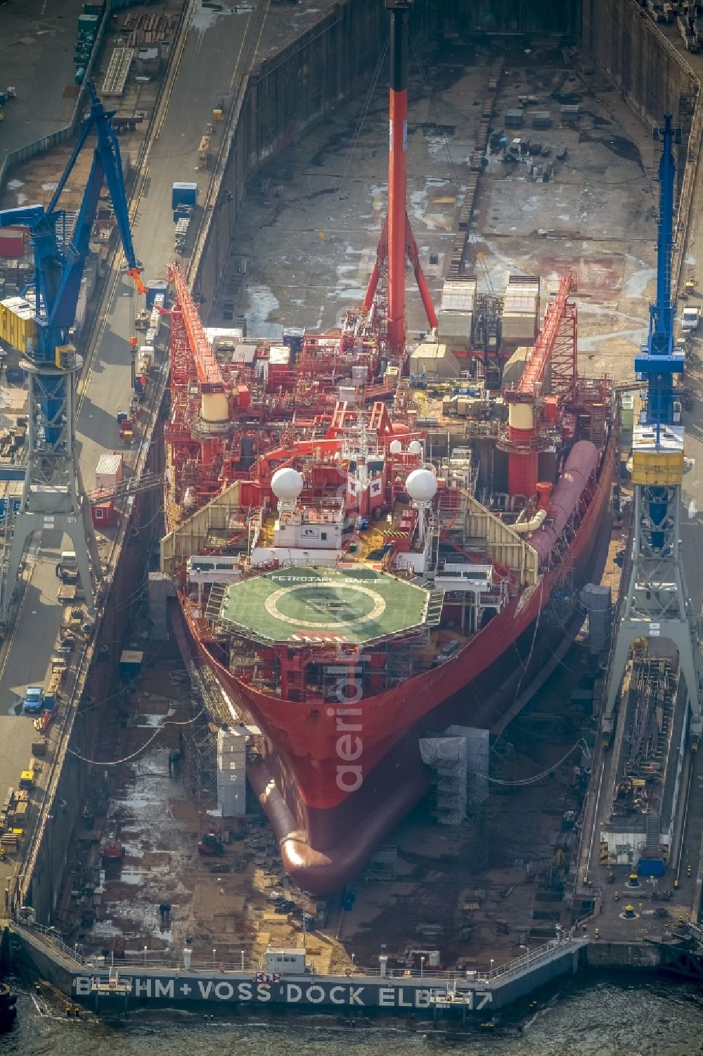 Hamburg from above - View of overhaul and maintenance work on the research vessel Petrojarl Banff in dry dock of Blohm and Voss Dock Elbe in Hamburg. The dry dock Elbe 17 is one of the largest dry dock in Europe. It is located on the grounds of the Blohm + Voss shipyard in Hamburg harbor