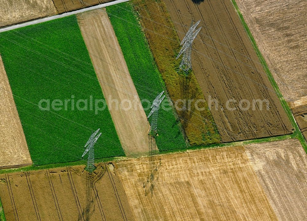 Heilbronn from the bird's eye view: Transmission lines and acres in the county district of Heilbronn in the state of Baden-Württemberg. The high voltage power lines are set up along the fields and acres in the district and the region. The different sizes, geometries and structures of the various fields in summer are very well visible