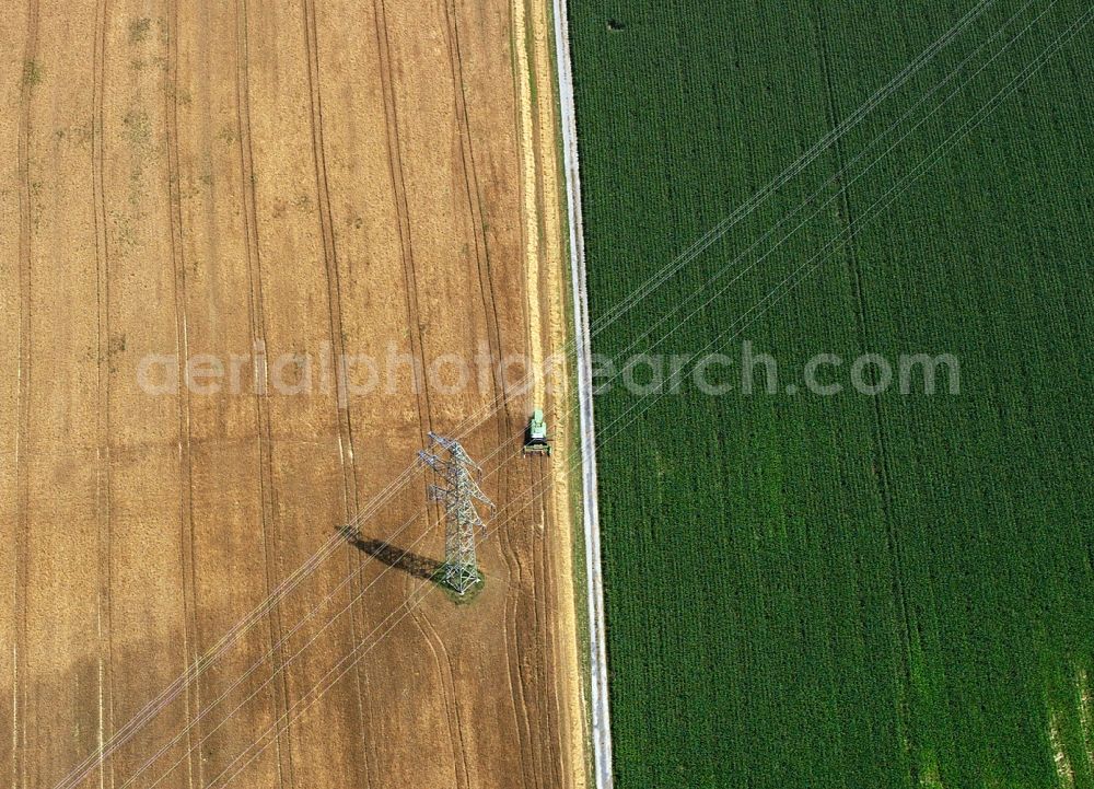 Aerial photograph Heilbronn - Transmission lines and acres in the county district of Heilbronn in the state of Baden-Württemberg. The high voltage power lines are set up along the fields and acres in the district and the region. The different sizes, geometries and structures of the various fields in summer are very well visible