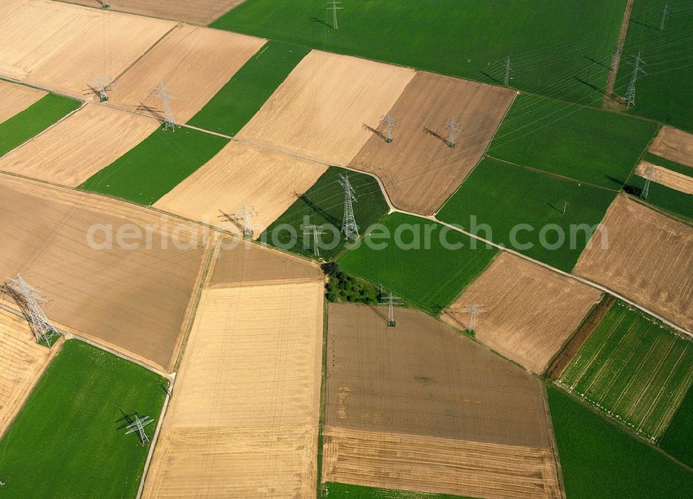 Heilbronn from the bird's eye view: Transmission lines and acres in the county district of Heilbronn in the state of Baden-Württemberg. The high voltage power lines are set up along the fields and acres in the district and the region. The different sizes, geometries and structures of the various fields in summer are very well visible