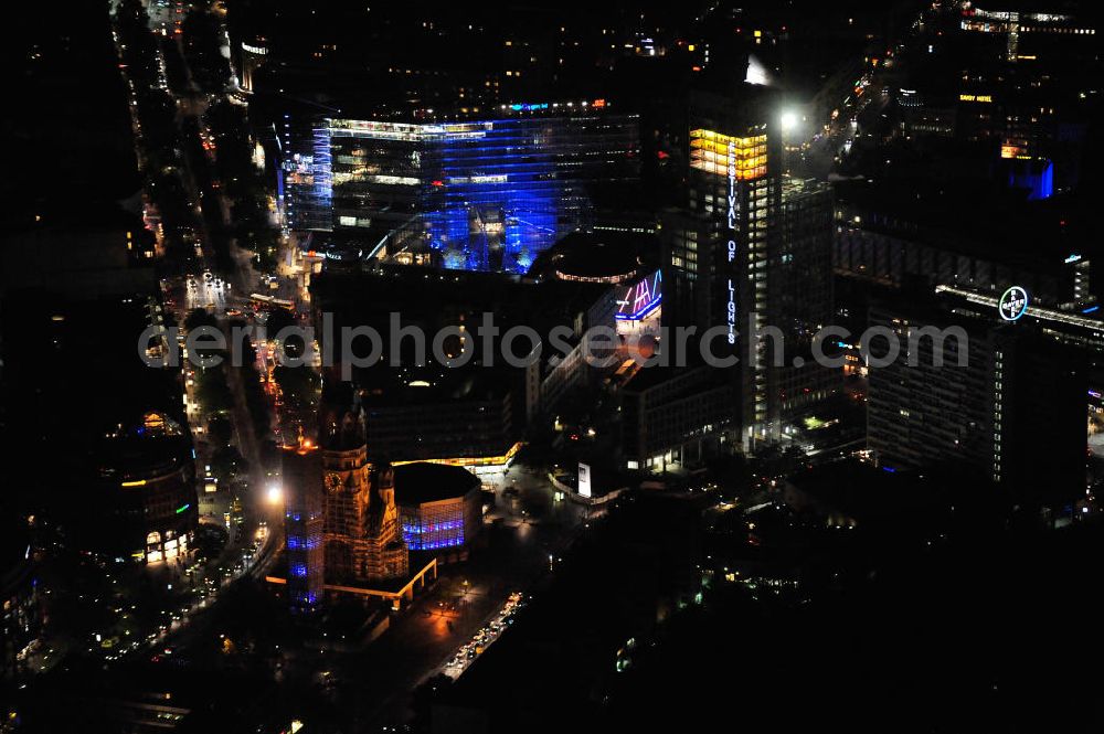 Berlin from above - Nachtaufnahme: Blick auf die Kaiser-Wilhelm-Gedächtniskirche am Breitscheidplatz mit Beleuchtung anläßlich des Festival of Lights. Der Breitscheidplatz liegt in Charlottenburg im Berliner Bezirk Charlottenburg-Wilmersdorf zwischen Kurfürstendamm und Budapester Straße (City West). Night Shot: The Kaiser Wilhelm Memorial Church at the square Breitscheidplatz with illumination at the Festival of Lights.