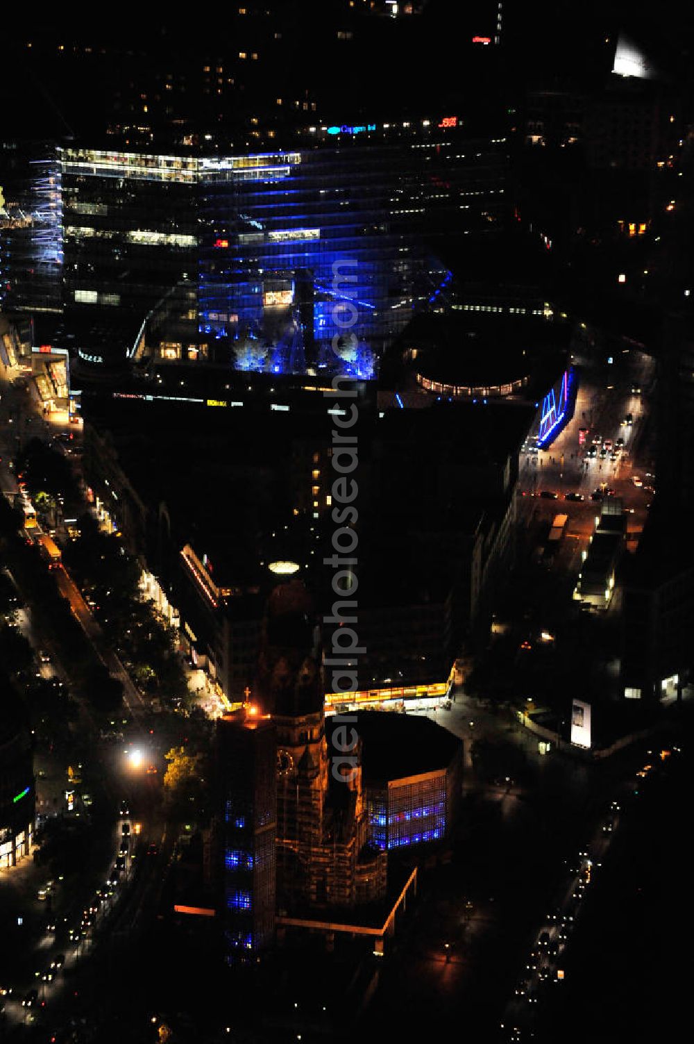 Berlin from the bird's eye view: Nachtaufnahme: Blick auf die Kaiser-Wilhelm-Gedächtniskirche am Breitscheidplatz mit Beleuchtung anläßlich des Festival of Lights. Der Breitscheidplatz liegt in Charlottenburg im Berliner Bezirk Charlottenburg-Wilmersdorf zwischen Kurfürstendamm und Budapester Straße (City West). Night Shot: The Kaiser Wilhelm Memorial Church at the square Breitscheidplatz with illumination at the Festival of Lights.