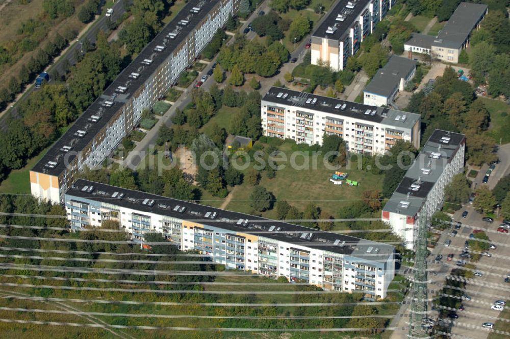 Aerial photograph Berlin - Blick durch eine Stromleitung / Strommast auf Mehrfamilienhäuser / Plattenbauten an der Karower Chaussee in Berlin-Buch.