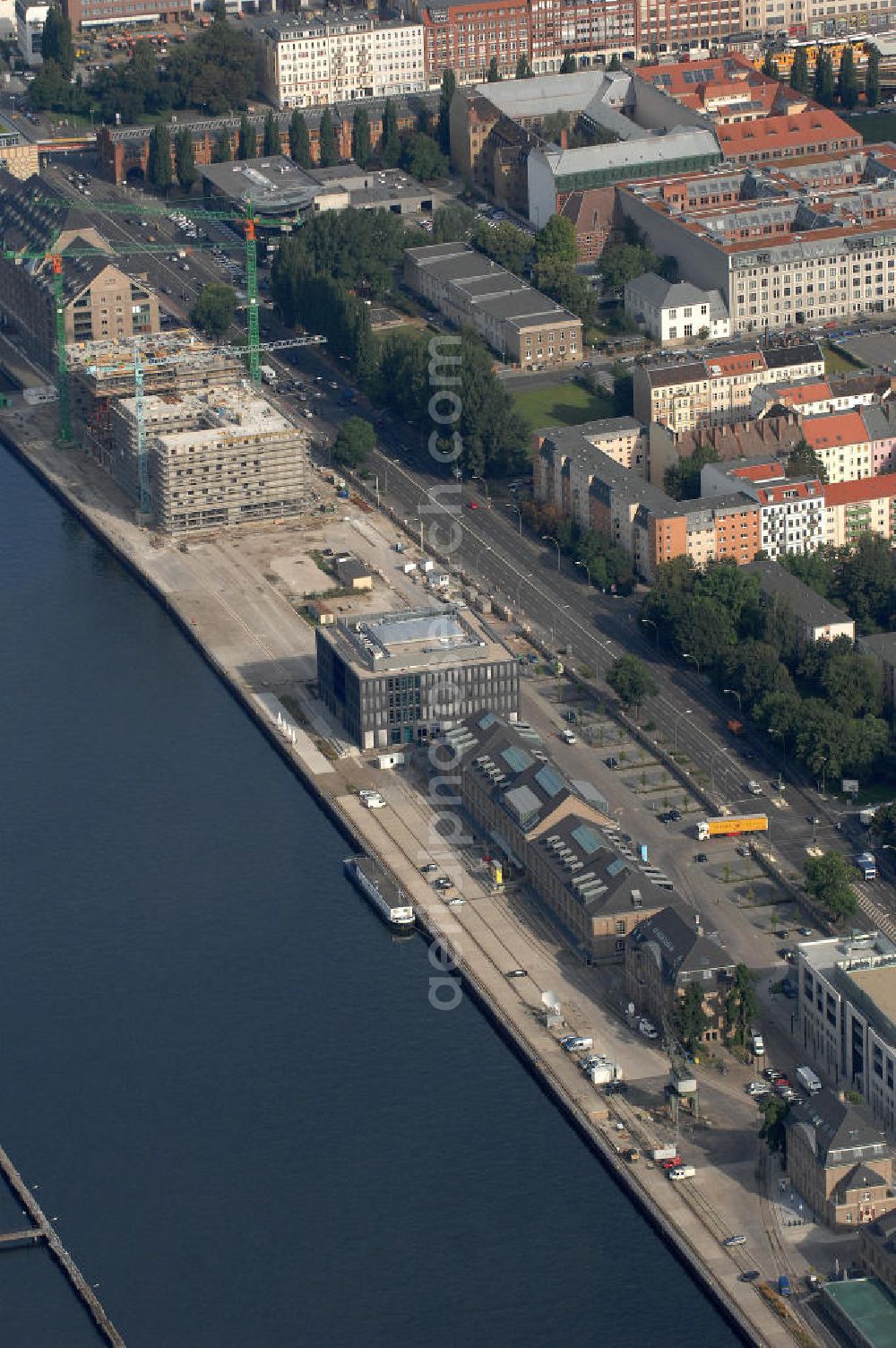 Aerial image Berlin - Blick über den Osthafen mit dem Bürogebäude und Sendeplatz des Musiksenders MTV. Adresse: MTV Networks Germany GmbH, Stralauer Allee 6-7, 10245 Berlin, Tel. +49 (0)30 700 100 0, Fax +49 (0)30 700 100 599. Im Hintergrund befindet sich die Baustelle für ein 4-Sterne-Hotel. Bauherr: NH Group Desk, Tel. +49 (0)180 3330 300, Fax +49 (0)180 2220 200, EMail tagungsservice@nh.hotels.com; Projektentwickler: NDC Nippon Development Corporation, Herr Peter Sauter, Clausewitzstraße 4, 10628 Berlin, Tel. +49 (0)30 889 13 380, Fax +49 (0)30 889 13 3850, EMail info@n-d-c.de