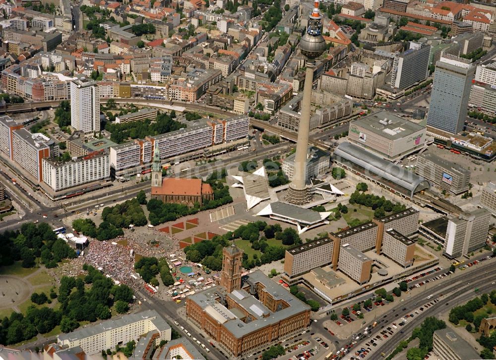 Berlin from the bird's eye view: Public square Alexanderplatz with rail station, TV Tower, the Red City Hall, the St. Mary`s Church and an demonstration at the Neptune Fountain in the district Mitte