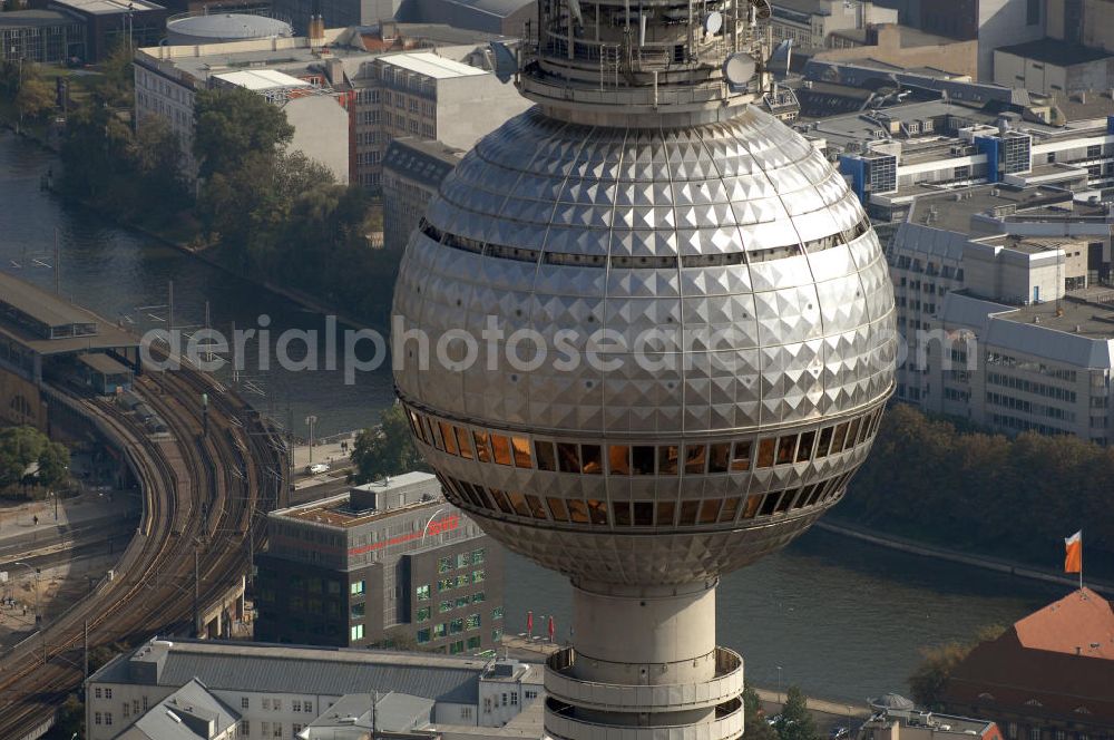 Aerial image Berlin - Der Berliner Fernsehturm ist mit 368 m das höchste Bauwerk Deutschlands und das vierthöchste freistehende Bauwerk Europas. Er befindet sich im östlichen Zentrum in Berlin-Mitte. Im Hintergrund ist die Spree zu sehen, sowie der S-Bahnhof Jannowitzbrücke. Berlin 2007/09/14 The Fernsehturm is a television tower in the center of Berlin, close to the Alexanderplatz. ol of the city. The picture shows the dome, where inside the visitor platform an the rotating restaurant in the middle of the sphere is. You can also see the river Spree and the railway station Jannowitzbrücke.