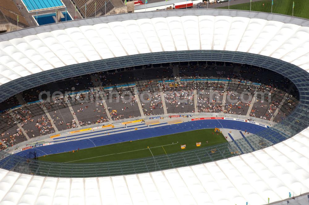 Aerial photograph Berlin - Blick auf das Berliner Olympiastadion, am Tag der Eröffnung der Leichtathletik WM 2009. Vom 15. bis 23. August 2009 findet in Berlin das weltgrößte Sportevent des Jahres 2009 statt - die Leichtathletik Weltmeisterschaft. Rund 1.800 Top-Athleten aus den 213 Mitgliedsverbänden des Weltverbandes IAAF treten im Kampf um die Medaillen in 47 Disziplinen im Berliner Olympiastadion an.