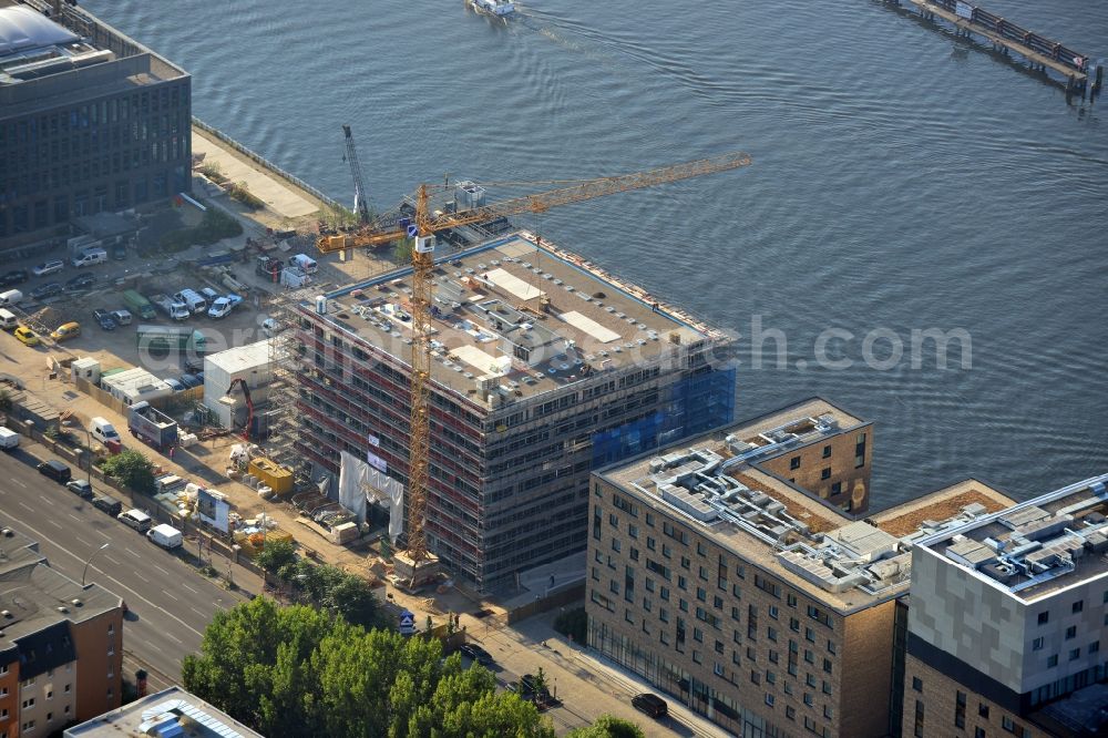 Aerial image Berlin - View of the construction site Berlins große Freiheit in Berlin-Friedrichshain. Next to the 4-star music-hotel nhow on Berlin's Osthafen to Berlins Große Freiheit arise, a seven-storey office building at Stralauer Allee. Construction is set for early 2011, scheduled for completion in mid 2012. The designs for Berlin Big Freedom are from nps tchoban voss, which had already planned the nhow-hotel