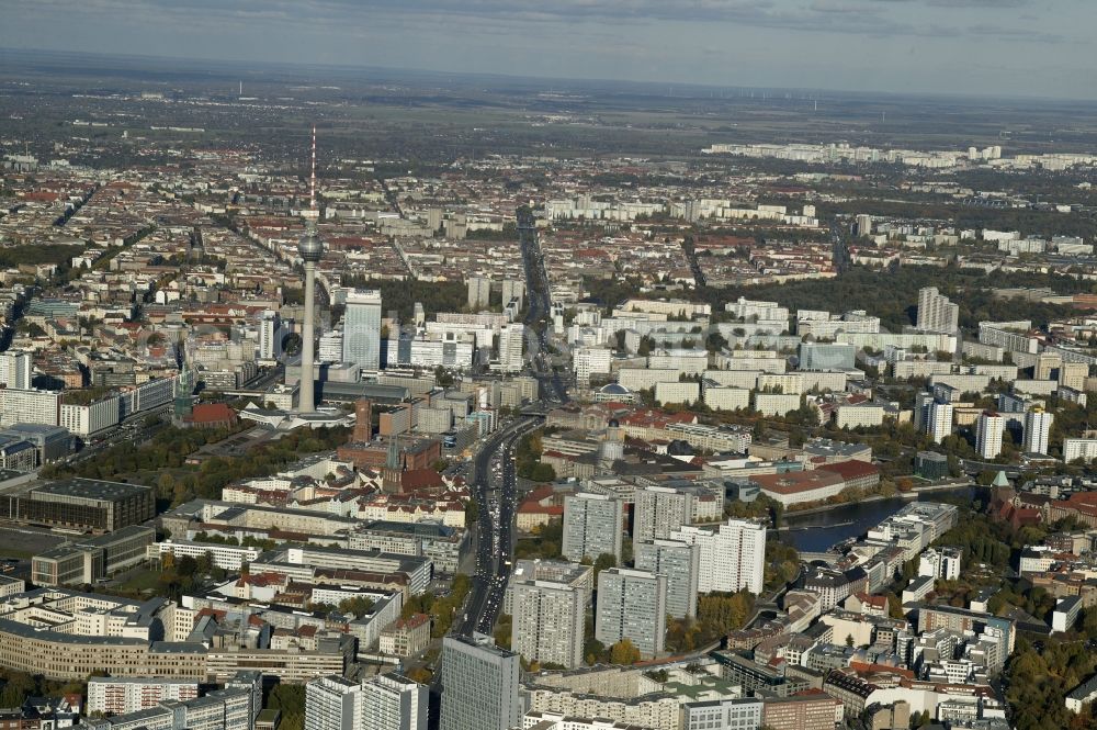 Aerial image Berlin - The Leipziger Strasse, with its striking high-rise buildings from the communist era sought as wide traffic lane north. Before flowing into the Greifswalderstrasse it passes the high-rise buildings on Fisherman's Island, the Nikolai Quarter with the Nikolai Church and the Alexanderplatz with the Berlin TV Tower and the ParkInn hotel. In the city center there are further of the Palace of the Republic, the Red City Hall and St. Mary's Church. In the background is distinguished by its bright prefabricated the development area Hohenschoenhausen from