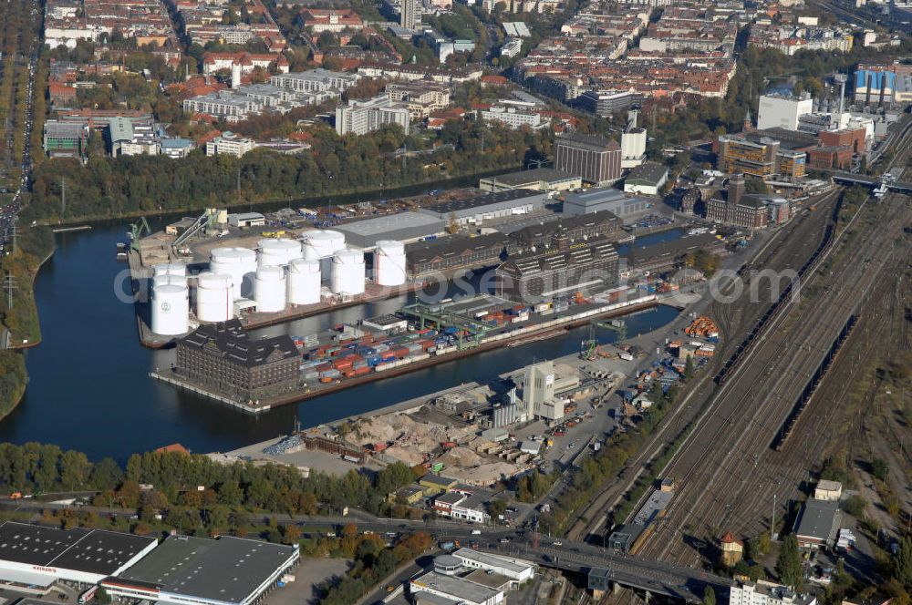 Aerial image Berlin - Der Berliner Westhafen ist ein Binnenhafen im Ortsteil Moabit des Bezirks Mitte. Der Westhafen ist mit einer Fläche von 430.000 m² der größte Hafen der Stadt und ein bedeutender Umschlag- und Lagerplatz für die Binnenschifffahrt. Die Berliner Hafen-und Lagerhausgesellschaft mbH, kurz BEHALA genannt, betreibt in Berlin mehrere Binnenhäfen mit den dazugehörigen Lagerhäusern, dem Güterumschlag, einer Bauschuttentsorgung, den Hafenbahnen, und die Vermietung von Immobilien auf den Hafengeländen. Sie ist ein Eigenbetrieb der Stadt Berlin. Weitere Informationen unter