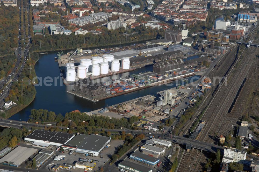 Aerial photograph Berlin - Der Berliner Westhafen ist ein Binnenhafen im Ortsteil Moabit des Bezirks Mitte. Der Westhafen ist mit einer Fläche von 430.000 m² der größte Hafen der Stadt und ein bedeutender Umschlag- und Lagerplatz für die Binnenschifffahrt. Die Berliner Hafen-und Lagerhausgesellschaft mbH, kurz BEHALA genannt, betreibt in Berlin mehrere Binnenhäfen mit den dazugehörigen Lagerhäusern, dem Güterumschlag, einer Bauschuttentsorgung, den Hafenbahnen, und die Vermietung von Immobilien auf den Hafengeländen. Sie ist ein Eigenbetrieb der Stadt Berlin. Weitere Informationen unter