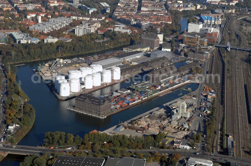 Berlin from above - Der Berliner Westhafen ist ein Binnenhafen im Ortsteil Moabit des Bezirks Mitte. Der Westhafen ist mit einer Fläche von 430.000 m² der größte Hafen der Stadt und ein bedeutender Umschlag- und Lagerplatz für die Binnenschifffahrt. Die Berliner Hafen-und Lagerhausgesellschaft mbH, kurz BEHALA genannt, betreibt in Berlin mehrere Binnenhäfen mit den dazugehörigen Lagerhäusern, dem Güterumschlag, einer Bauschuttentsorgung, den Hafenbahnen, und die Vermietung von Immobilien auf den Hafengeländen. Sie ist ein Eigenbetrieb der Stadt Berlin. Weitere Informationen unter