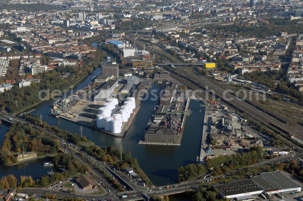 Aerial image Berlin - Der Berliner Westhafen ist ein Binnenhafen im Ortsteil Moabit des Bezirks Mitte. Der Westhafen ist mit einer Fläche von 430.000 m² der größte Hafen der Stadt und ein bedeutender Umschlag- und Lagerplatz für die Binnenschifffahrt. Die Berliner Hafen-und Lagerhausgesellschaft mbH, kurz BEHALA genannt, betreibt in Berlin mehrere Binnenhäfen mit den dazugehörigen Lagerhäusern, dem Güterumschlag, einer Bauschuttentsorgung, den Hafenbahnen, und die Vermietung von Immobilien auf den Hafengeländen. Sie ist ein Eigenbetrieb der Stadt Berlin. Weitere Informationen unter