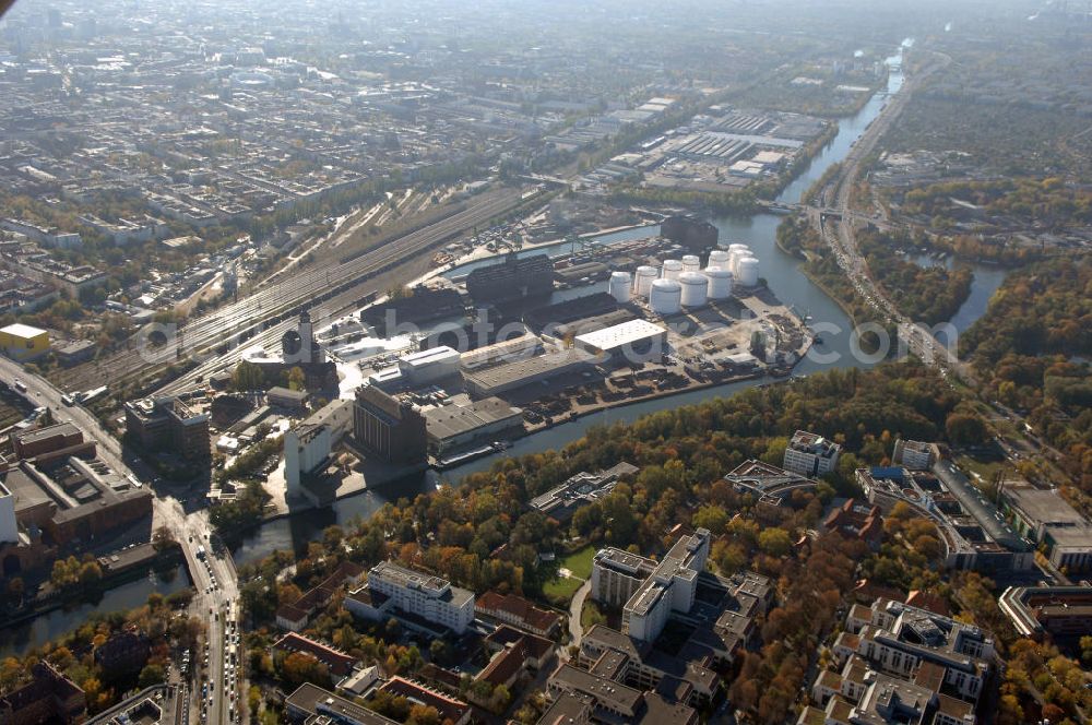 Aerial photograph Berlin - Der Berliner Westhafen ist ein Binnenhafen im Ortsteil Moabit des Bezirks Mitte. Der Westhafen ist mit einer Fläche von 430.000 m² der größte Hafen der Stadt und ein bedeutender Umschlag- und Lagerplatz für die Binnenschifffahrt. Die Berliner Hafen-und Lagerhausgesellschaft mbH, kurz BEHALA genannt, betreibt in Berlin mehrere Binnenhäfen mit den dazugehörigen Lagerhäusern, dem Güterumschlag, einer Bauschuttentsorgung, den Hafenbahnen, und die Vermietung von Immobilien auf den Hafengeländen. Sie ist ein Eigenbetrieb der Stadt Berlin. Weitere Informationen unter