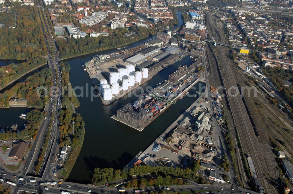 Aerial photograph Berlin - Der Berliner Westhafen ist ein Binnenhafen im Ortsteil Moabit des Bezirks Mitte. Der Westhafen ist mit einer Fläche von 430.000 m² der größte Hafen der Stadt und ein bedeutender Umschlag- und Lagerplatz für die Binnenschifffahrt. Die Berliner Hafen-und Lagerhausgesellschaft mbH, kurz BEHALA genannt, betreibt in Berlin mehrere Binnenhäfen mit den dazugehörigen Lagerhäusern, dem Güterumschlag, einer Bauschuttentsorgung, den Hafenbahnen, und die Vermietung von Immobilien auf den Hafengeländen. Sie ist ein Eigenbetrieb der Stadt Berlin. Weitere Informationen unter