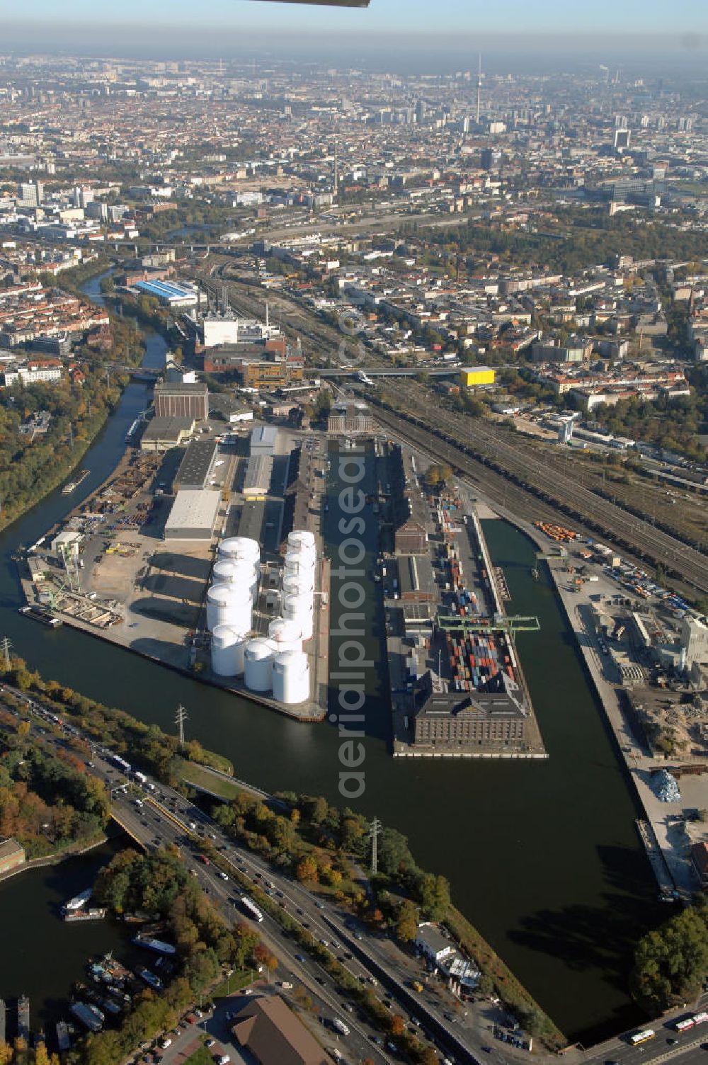 Aerial image Berlin - Der Berliner Westhafen ist ein Binnenhafen im Ortsteil Moabit des Bezirks Mitte. Der Westhafen ist mit einer Fläche von 430.000 m² der größte Hafen der Stadt und ein bedeutender Umschlag- und Lagerplatz für die Binnenschifffahrt. Die Berliner Hafen-und Lagerhausgesellschaft mbH, kurz BEHALA genannt, betreibt in Berlin mehrere Binnenhäfen mit den dazugehörigen Lagerhäusern, dem Güterumschlag, einer Bauschuttentsorgung, den Hafenbahnen, und die Vermietung von Immobilien auf den Hafengeländen. Sie ist ein Eigenbetrieb der Stadt Berlin. Weitere Informationen unter