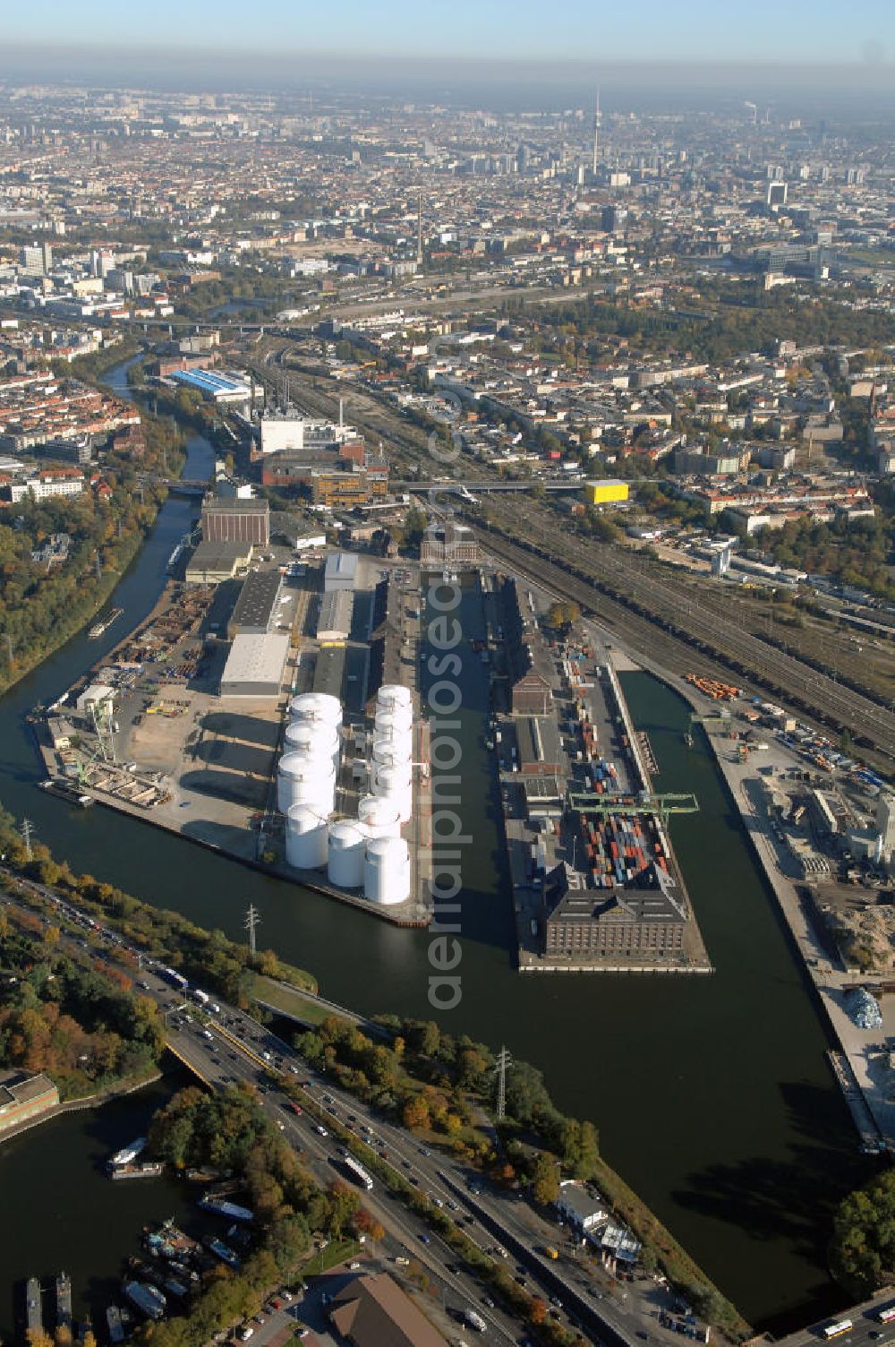 Aerial photograph Berlin - Der Berliner Westhafen ist ein Binnenhafen im Ortsteil Moabit des Bezirks Mitte. Der Westhafen ist mit einer Fläche von 430.000 m² der größte Hafen der Stadt und ein bedeutender Umschlag- und Lagerplatz für die Binnenschifffahrt. Die Berliner Hafen-und Lagerhausgesellschaft mbH, kurz BEHALA genannt, betreibt in Berlin mehrere Binnenhäfen mit den dazugehörigen Lagerhäusern, dem Güterumschlag, einer Bauschuttentsorgung, den Hafenbahnen, und die Vermietung von Immobilien auf den Hafengeländen. Sie ist ein Eigenbetrieb der Stadt Berlin. Weitere Informationen unter