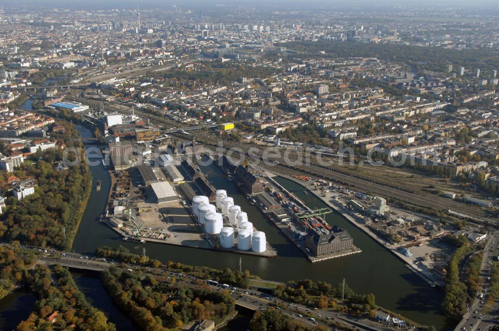 Aerial photograph Berlin - Der Berliner Westhafen ist ein Binnenhafen im Ortsteil Moabit des Bezirks Mitte. Der Westhafen ist mit einer Fläche von 430.000 m² der größte Hafen der Stadt und ein bedeutender Umschlag- und Lagerplatz für die Binnenschifffahrt. Die Berliner Hafen-und Lagerhausgesellschaft mbH, kurz BEHALA genannt, betreibt in Berlin mehrere Binnenhäfen mit den dazugehörigen Lagerhäusern, dem Güterumschlag, einer Bauschuttentsorgung, den Hafenbahnen, und die Vermietung von Immobilien auf den Hafengeländen. Sie ist ein Eigenbetrieb der Stadt Berlin. Weitere Informationen unter