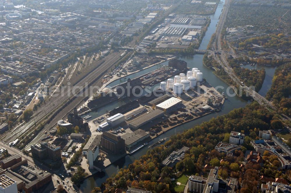 Berlin from the bird's eye view: Der Berliner Westhafen ist ein Binnenhafen im Ortsteil Moabit des Bezirks Mitte. Der Westhafen ist mit einer Fläche von 430.000 m² der größte Hafen der Stadt und ein bedeutender Umschlag- und Lagerplatz für die Binnenschifffahrt. Die Berliner Hafen-und Lagerhausgesellschaft mbH, kurz BEHALA genannt, betreibt in Berlin mehrere Binnenhäfen mit den dazugehörigen Lagerhäusern, dem Güterumschlag, einer Bauschuttentsorgung, den Hafenbahnen, und die Vermietung von Immobilien auf den Hafengeländen. Sie ist ein Eigenbetrieb der Stadt Berlin. Weitere Informationen unter