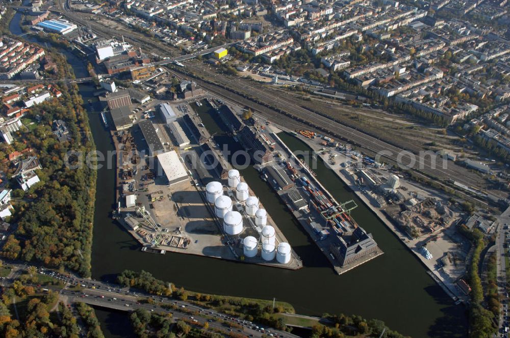 Aerial photograph Berlin - Der Berliner Westhafen ist ein Binnenhafen im Ortsteil Moabit des Bezirks Mitte. Der Westhafen ist mit einer Fläche von 430.000 m² der größte Hafen der Stadt und ein bedeutender Umschlag- und Lagerplatz für die Binnenschifffahrt. Die Berliner Hafen-und Lagerhausgesellschaft mbH, kurz BEHALA genannt, betreibt in Berlin mehrere Binnenhäfen mit den dazugehörigen Lagerhäusern, dem Güterumschlag, einer Bauschuttentsorgung, den Hafenbahnen, und die Vermietung von Immobilien auf den Hafengeländen. Sie ist ein Eigenbetrieb der Stadt Berlin. Weitere Informationen unter