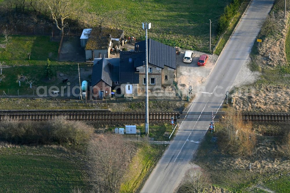 Groß Daberkow from the bird's eye view: Roads - barriers at a level crossing in the rail track route network of the Deutsche Bahn with old gate keeper's house in Gross Daberkow in the state Mecklenburg - Western Pomerania, Germany