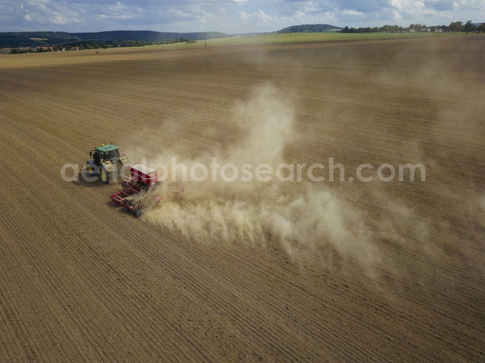 Dohma from above - Cultivation of a field using a tractor with agricultural machine for sowing on street Am Kirschberg in Dohma in the state Saxony, Germany