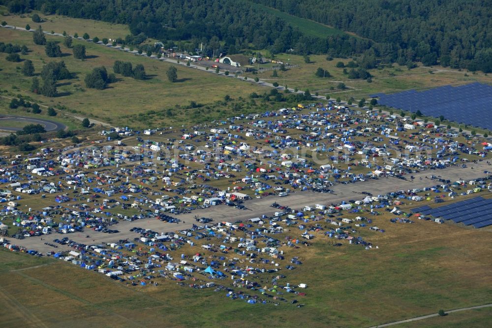 JÜTERBOG from the bird's eye view: Views of visitors to the Motorcycle Jamboree Festival on the disused runway of the airfield Altes Lager in Jueterbog in the state of Brandenburg. The Motorcycle Jamboree is aimed primarily at motorcycle enthusiasts. It play music live bands in the style of Rock, Hard Rock, Blues Rock, Heavy Metal and there is a program with bike shows, motorcycle games. http://