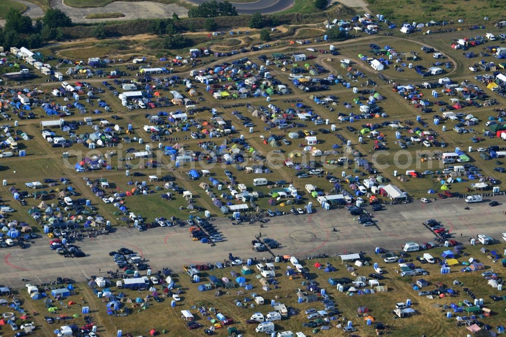 Aerial image JÜTERBOG - Views of visitors to the Motorcycle Jamboree Festival on the disused runway of the airfield Altes Lager in Jueterbog in the state of Brandenburg. The Motorcycle Jamboree is aimed primarily at motorcycle enthusiasts. It play music live bands in the style of Rock, Hard Rock, Blues Rock, Heavy Metal and there is a program with bike shows, motorcycle games. http://