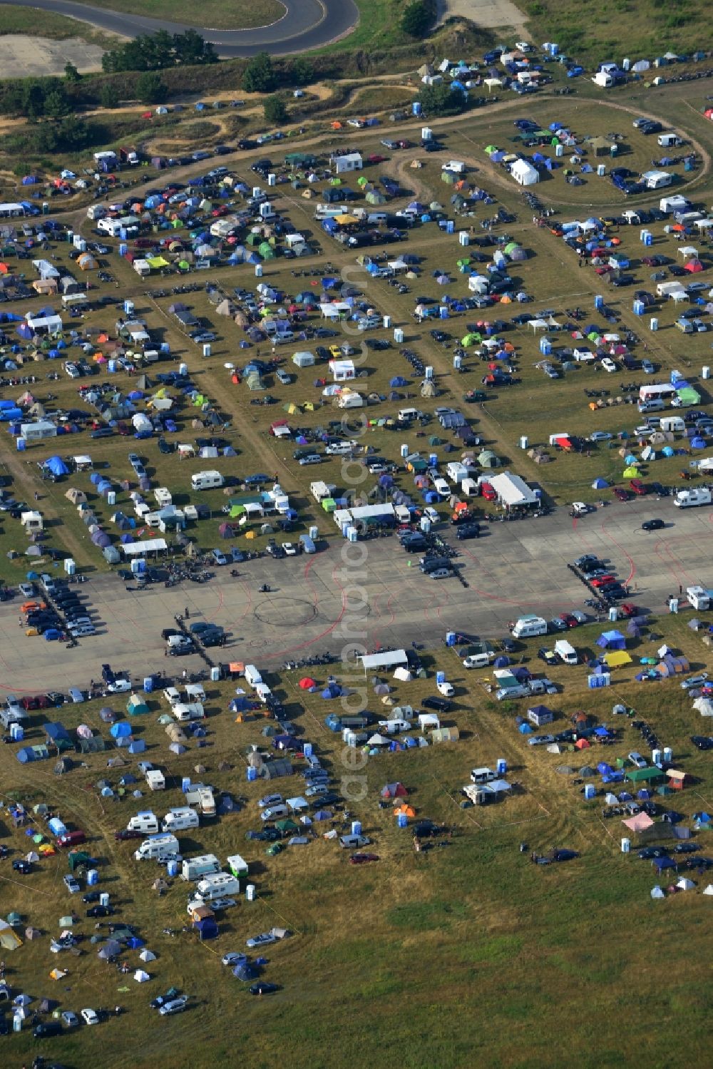 Aerial photograph JÜTERBOG - Views of visitors to the Motorcycle Jamboree Festival on the disused runway of the airfield Altes Lager in Jueterbog in the state of Brandenburg. The Motorcycle Jamboree is aimed primarily at motorcycle enthusiasts. It play music live bands in the style of Rock, Hard Rock, Blues Rock, Heavy Metal and there is a program with bike shows, motorcycle games. http://