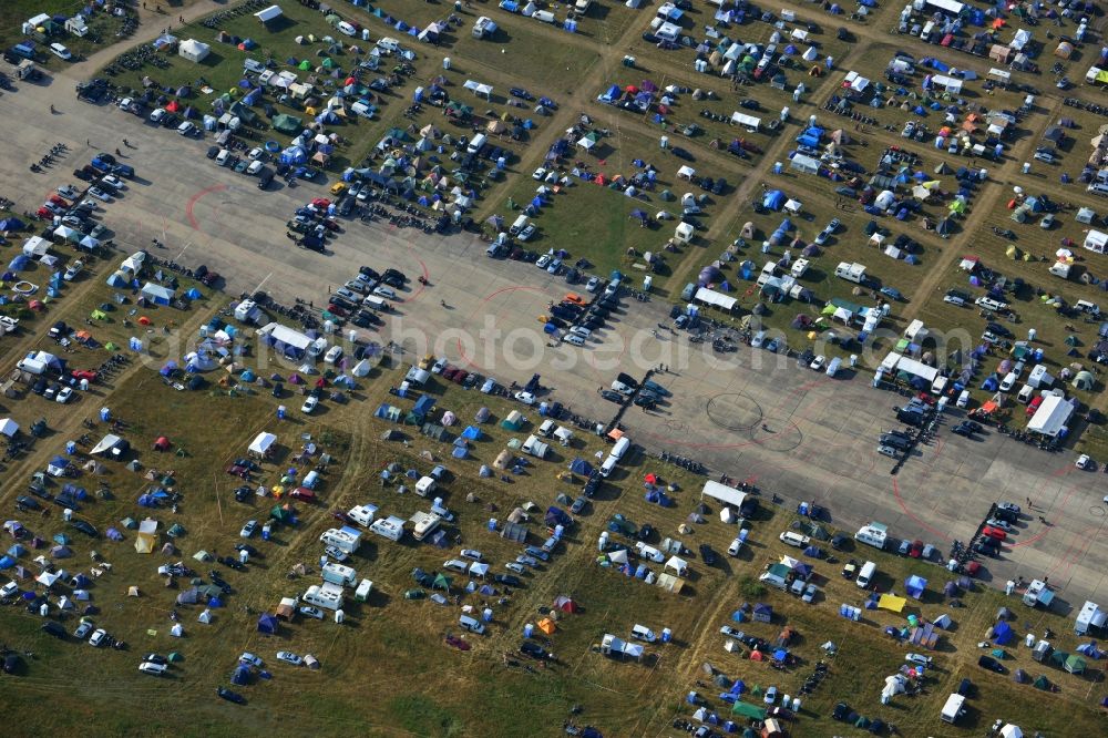 JÜTERBOG from above - Views of visitors to the Motorcycle Jamboree Festival on the disused runway of the airfield Altes Lager in Jueterbog in the state of Brandenburg. The Motorcycle Jamboree is aimed primarily at motorcycle enthusiasts. It play music live bands in the style of Rock, Hard Rock, Blues Rock, Heavy Metal and there is a program with bike shows, motorcycle games. http://