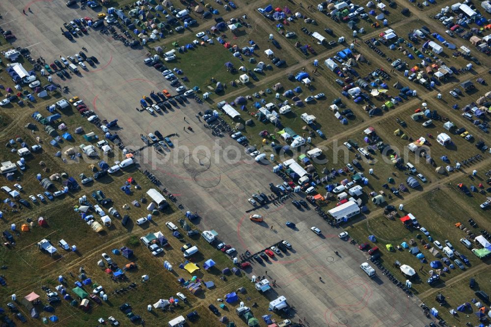 JÜTERBOG from the bird's eye view: Views of visitors to the Motorcycle Jamboree Festival on the disused runway of the airfield Altes Lager in Jueterbog in the state of Brandenburg. The Motorcycle Jamboree is aimed primarily at motorcycle enthusiasts. It play music live bands in the style of Rock, Hard Rock, Blues Rock, Heavy Metal and there is a program with bike shows, motorcycle games. http://