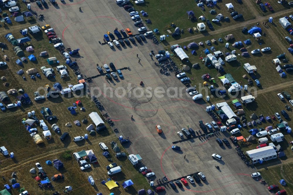 Aerial image JÜTERBOG - Views of visitors to the Motorcycle Jamboree Festival on the disused runway of the airfield Altes Lager in Jueterbog in the state of Brandenburg. The Motorcycle Jamboree is aimed primarily at motorcycle enthusiasts. It play music live bands in the style of Rock, Hard Rock, Blues Rock, Heavy Metal and there is a program with bike shows, motorcycle games. http://