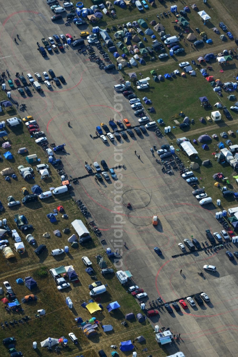 Aerial photograph JÜTERBOG - Views of visitors to the Motorcycle Jamboree Festival on the disused runway of the airfield Altes Lager in Jueterbog in the state of Brandenburg. The Motorcycle Jamboree is aimed primarily at motorcycle enthusiasts. It play music live bands in the style of Rock, Hard Rock, Blues Rock, Heavy Metal and there is a program with bike shows, motorcycle games. http://